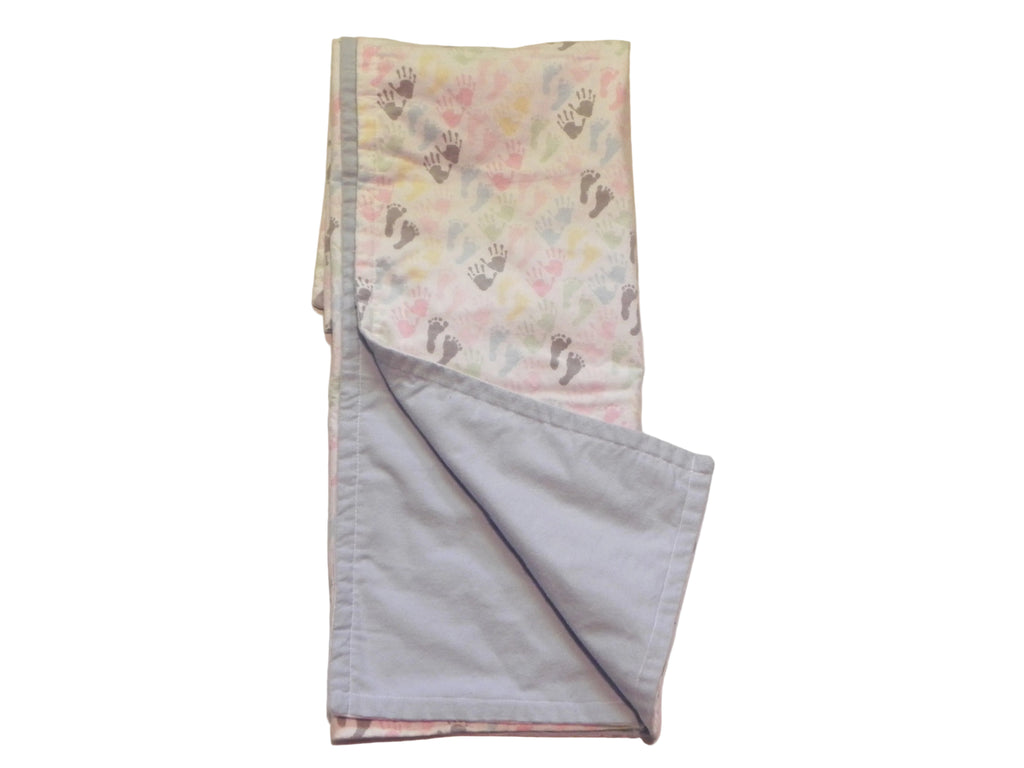 Pastel flannel baby blanket showing blue flannel backing