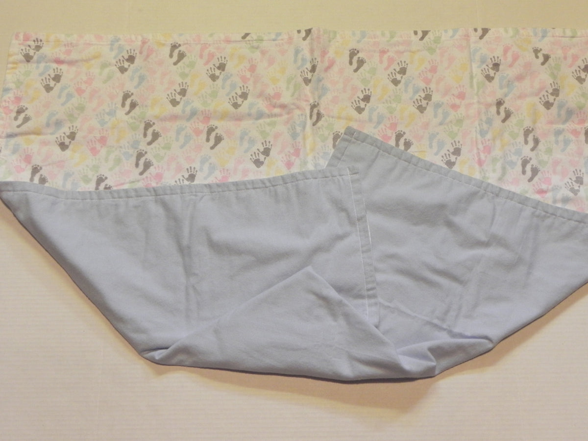 Pastel flannel baby blanket with hand and footprint print and blue backing