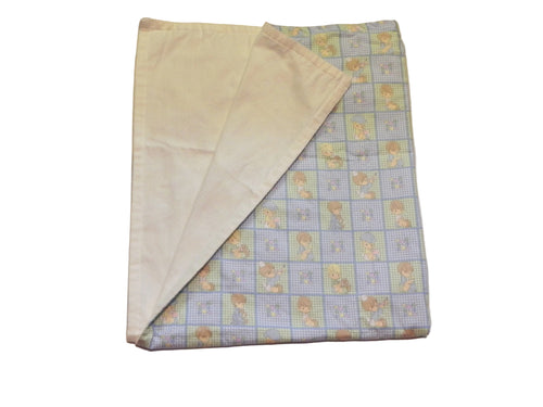 Blue-and-white children’s print baby blanket showing cotton front and white flannel back